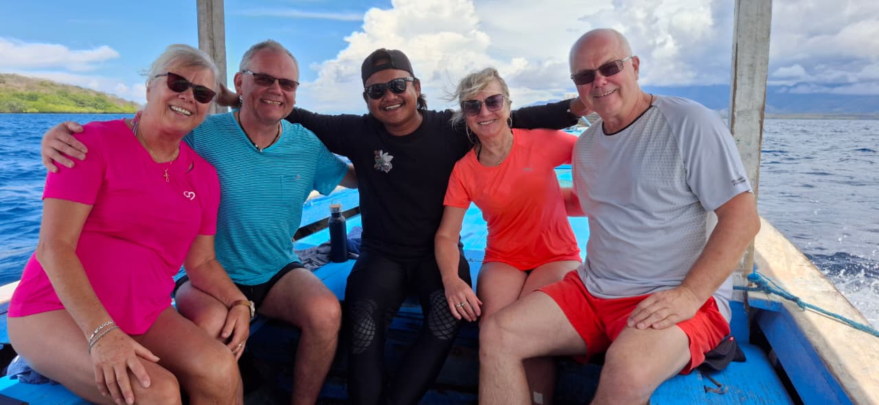 Balifornia guide with guests on a boat